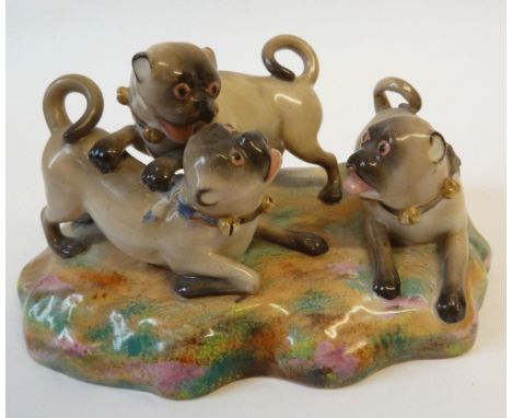 ROYAL WORCESTER GROUP OF THREE PLAYFUL PUG DOGS EACH WEARING COLLAR WITH BELLS, naturalistic oval base, 7" (17.8cm) wide, (ci