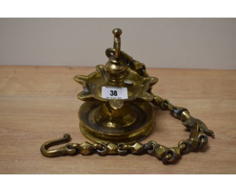 A heavy brass Middle Eastern style suspending oil lamp with chain, L63cm.