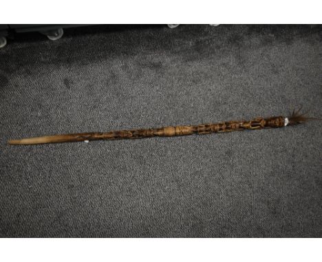 An early 20th century hand carved African tribal Tiki walking stick, decorated depicting elongated figures and feather top, h
