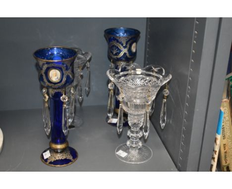 A pair of late 19th / early 20th century blue glass lustres having tear drop crystal pendents, decorated with gold coloured s