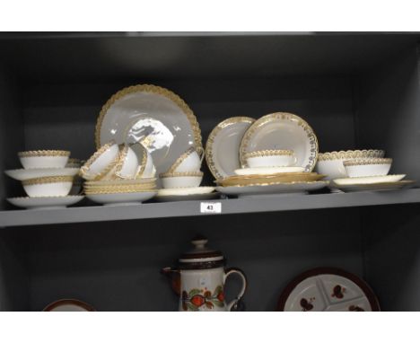 A fine bone China part tea / dinner service, having gilt flared edging and foliage motif patterns on a white ground, impresse