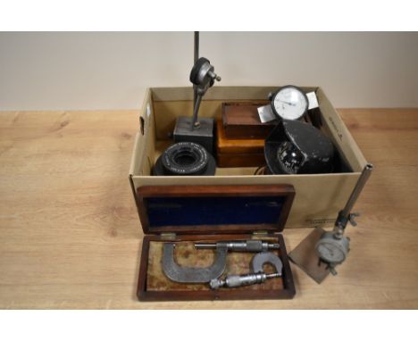 A box containing various measuring instruments, to include an airguide dash mounted compass, a cased micrometer, a Schneider-