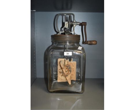 A large vintage blown glass butter churn, having pine handle and impressed manufacturing marks to front, H40cm.