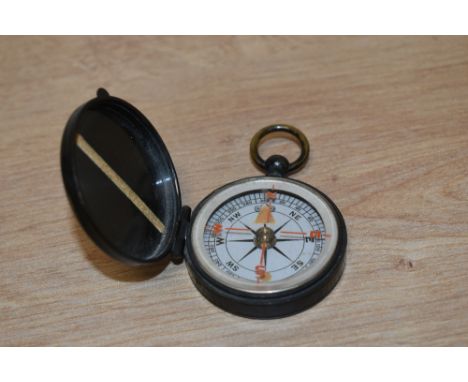 A 20th century pocket compass, of hinged circular form with suspension ring 5cm diameter