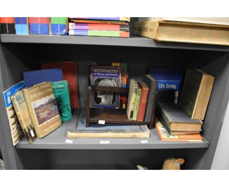 An early 20th century oak book trough stand, L29.5cm, sold together with a selection of books, to include A Book for Young Sp