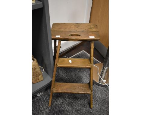 A late 19th /early 20th century pine two tier folding step ladder, having iron fixtures, h60cm.