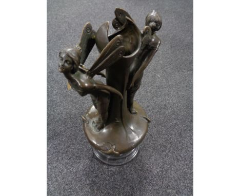 A bronze vase surmounted by two fairies 