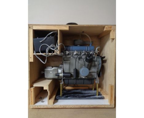 A scratch built plastic model of a combustion engine in wooden crate 