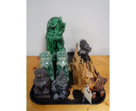 A tray of decorative Chinese modern carvings, resin figures, ceramic temple dog etc  CONDITION REPORT: Two of the dogs with s