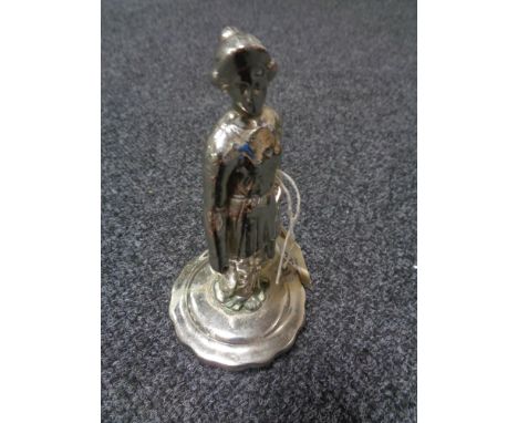 An early motoring car mascot of a chrome plated Edwardian lady, mounted on its vintage car radiator cap, circa 1910. 