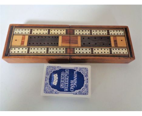 An antique inlaid cribbage board and cards