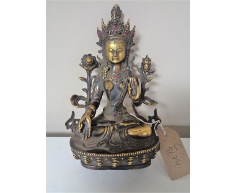A patinated bronze deity figure in lotus position, with jewelled cabochon decoration, height approximately 21 cm. CONDITION R