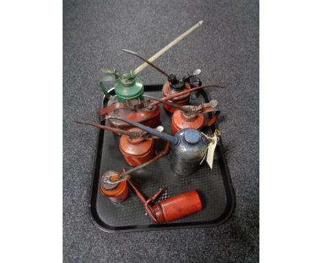 A tray of seven vintage oil cans 