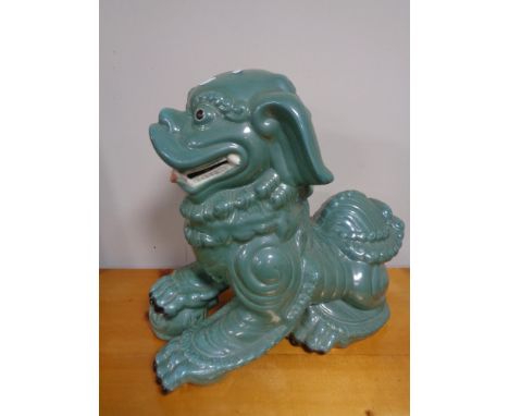 A large ceramic Temple dog with ball 