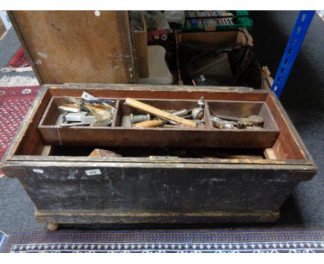 An antique pine joiner's tool chest containing hand tools 