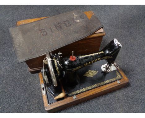 A vintage oak cased Singer hand sewing machine 