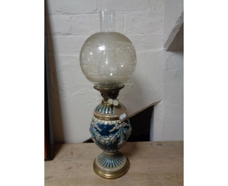 An antique glazed pottery and brass oil lamp with chimney and shade  CONDITION REPORT: Some chips to rim of shade. Chimney go