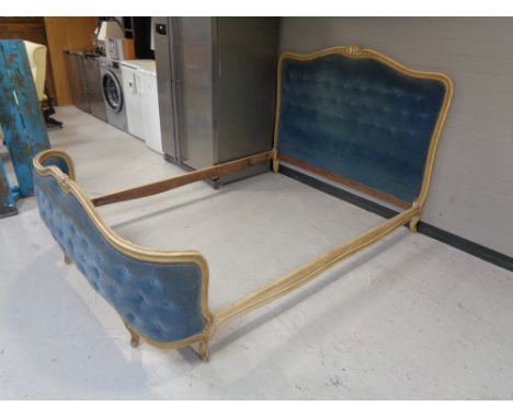 An early 20th century 5' bed frame in blue button dralon 