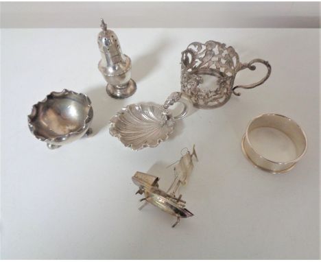 A silver miniature shell, together with a miniature white metal boat, silver salt, silver napkin ring, silver pepperette and 