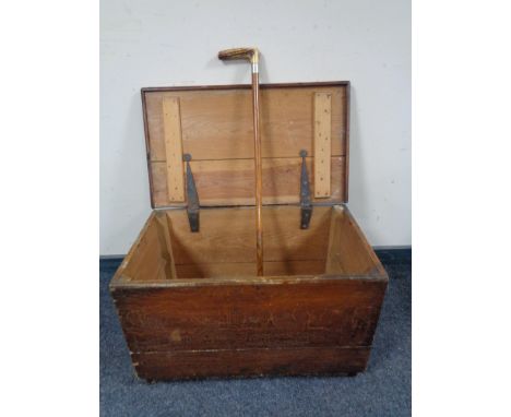 An antique pine blanket box and a walking stick 