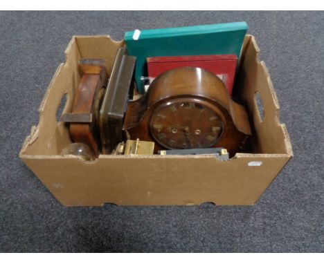 A box of assorted clocks, Hillman workshop manual, miniature pyramid tripod, rug 