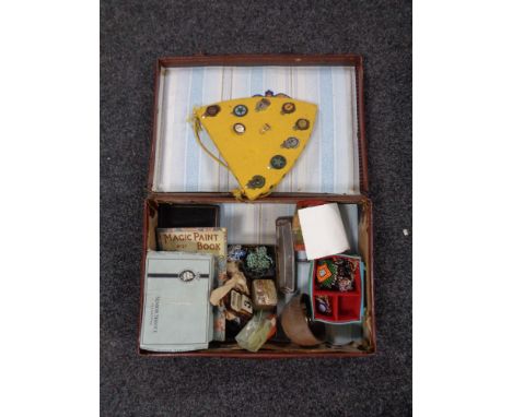 A vintage leather case containing miscellany to include costume jewellery, harmonica, treen barrel, Teacher's Association pin
