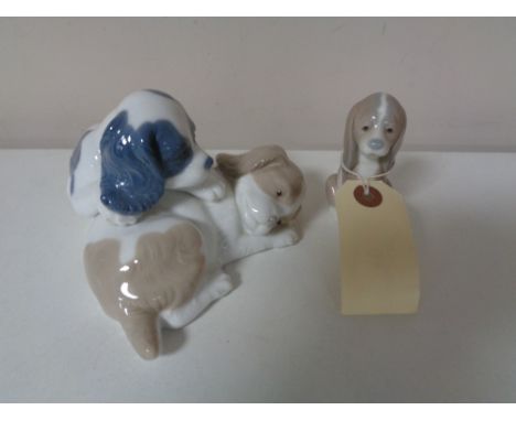 A Lladro and Nao figure group - dogs 