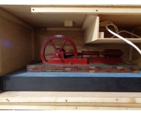 A scratch built plastic model of an engine in wooden crate 