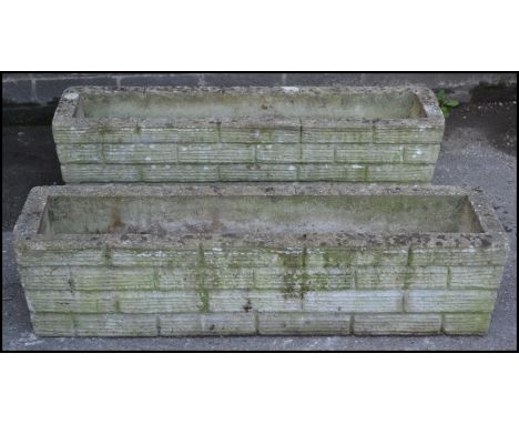 A pair of 20th Century well weather reconstituted garden planters of rectangular trough form, moulded in the form of brickwor