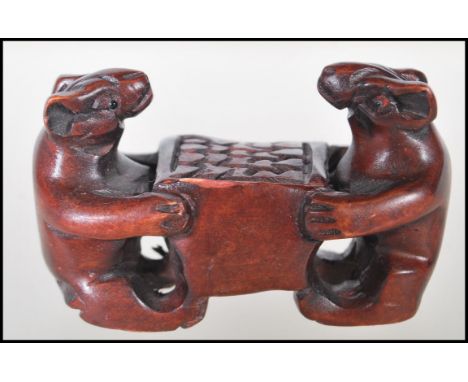 A 20th Century Japanese boxwood carved netsuke in the from of two mice. Measures 4cm tall by 7cm wide.&nbsp;