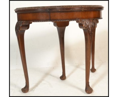 An early 20th Century Art Deco demi-lune card console table having a shaped walnut veneered opening top revealing a recess un