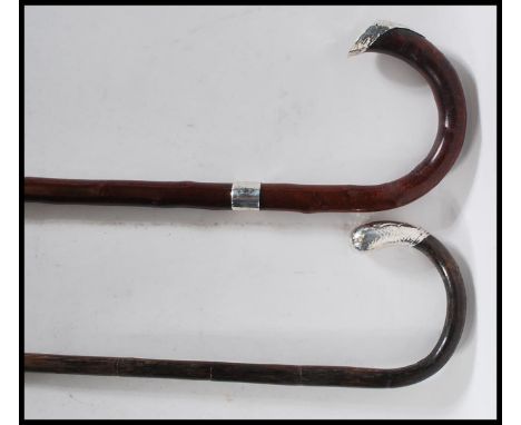 Two 20th Century walking stick canes to include a bamboo walking stick with a crook handle with a silver hallmarked knop to t