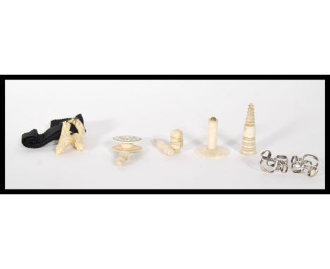 A collection of Victorian 19th Century Ivory items to include chess piece, thimble, thread holder and other decoratively carv