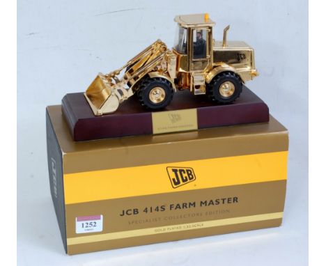 An Ertl gold plated 1:32 scale model of a JCB 414S Farm Master tractor shovel, specialist collector's edition, finished in go