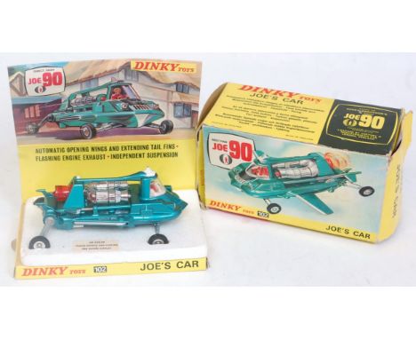 A Dinky Toys No. 102 Joe's Car comprising of metallic blue body with white fold-out wings and chrome and red plastic engine f