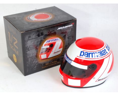 A KC Sports International 1:2 scale miniature replica Niki Lauda World Champion 1984 F1 racing helmet, appears as issued in t