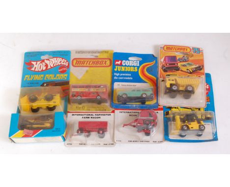 One box containing a quantity of boxed and carded construction and commercial vehicles to include a Matchbox MB64 bull dozer,