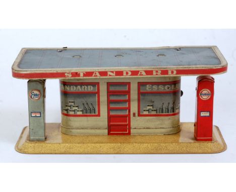 A tinplate Standard Petrol garage fitted with battery operation to power light fitting, comprising red, cream and grey tin pr