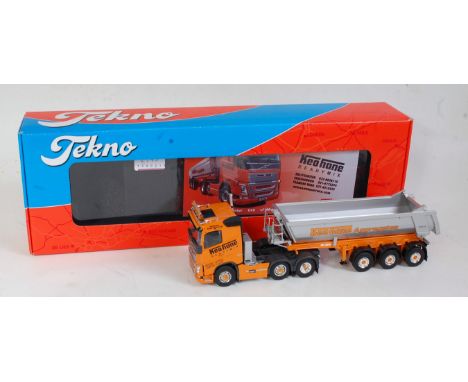 A Tekno 1:50 scale model of a Volvo FH550 tractor unit and a Keohane Aggregates tipper trailer, comprising orange and silver 