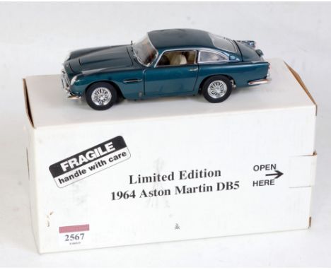 A Danbury Mint limited edition 1:24 scale model of a 1964 Aston Martin DB5, finished in metallic dark blue with cream interio