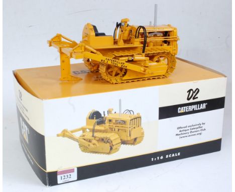 A Speccast 1:16 scale diecast model of a Caterpillar D2 track type tractor with tool bar ripper, 5U series, in Caterpillar ye