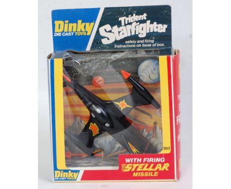 A Dinky Toys No. 362 Trident Star Fighter comprising black &amp; orange body with yellow and orange stickers across the body,