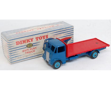 A Dinky Toys No. 512 guy flat truck, comprising dark blue cab and chassis with light blue hubs and red back, in the original 