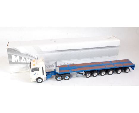 A Conrad No. 70155 1:50 scale model of a man TGX SL 6x2 tractor unit with Goldhofer ballast trailer finished in white and blu