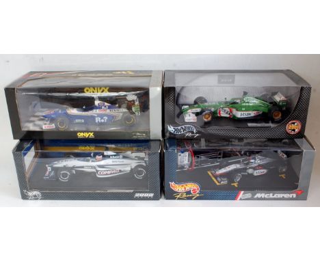 Four various boxed 1:18 scale Hot Wheels and Onyx F1 racing diecasts to include a Jaguar R2 Eddie Irvine Formula One racing c
