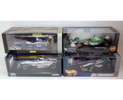 Four various boxed 1:18 scale Hot Wheels and Onyx F1 racing diecasts to include a Jaguar R2 Eddie Irvine Formula One racing c