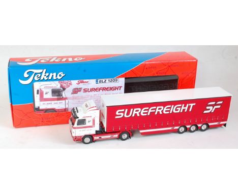 A Tekno 1:50 scale model of a Scania V8 450 tractor unit and curtainside trailer, finished in white and red with Surefreight 