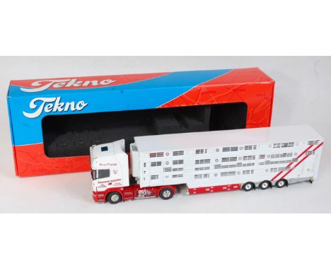 A Tekno 1:50 scale model of a Scania R620 tractor unit and livestock trailer, comprising white and red body with matching tra