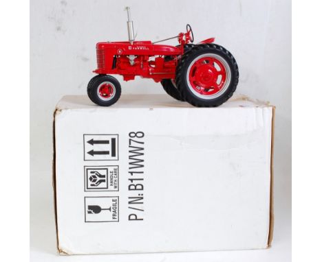 A Franklin Mint 1:12 scale diecast model of a Farmall Model H tractor, comprising red body with red hubs and silver detailing