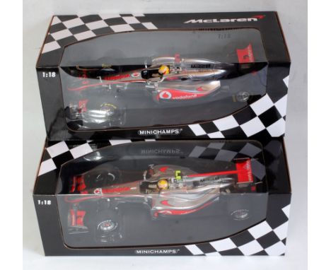 A Minichamps box 1/18 scale boxed F1 racing car group to include a Vodafone Maclaren Mercedes MP4-25 Lewis Hamilton 2010, tog